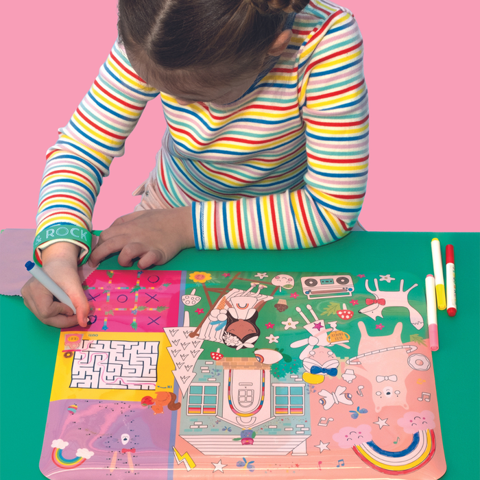 Girl playing with Floss and Rock Play Mat